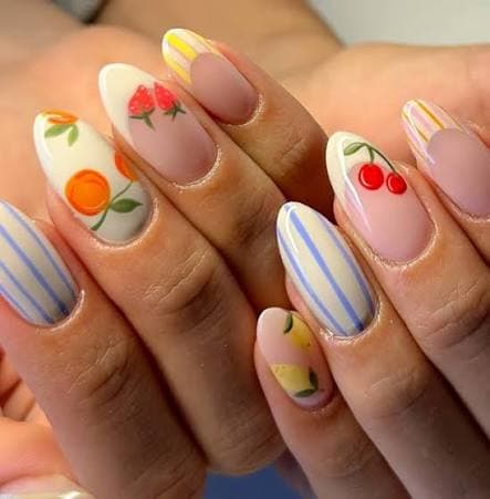 Colourful fruit nail art featuring cherries, oranges and lemons
